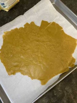 Dog treat dough rolled out on baking sheet