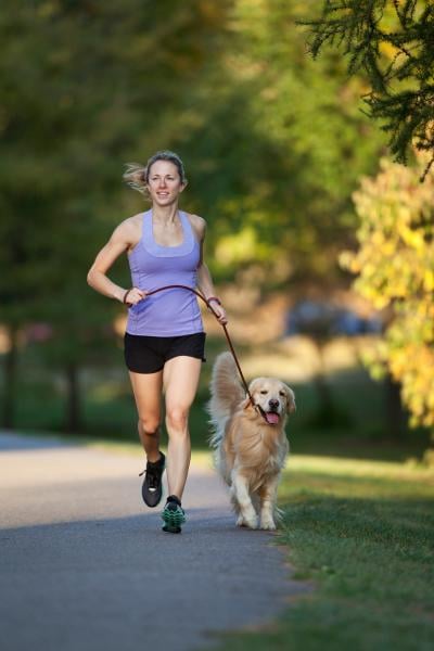 woman running with golden retriever
